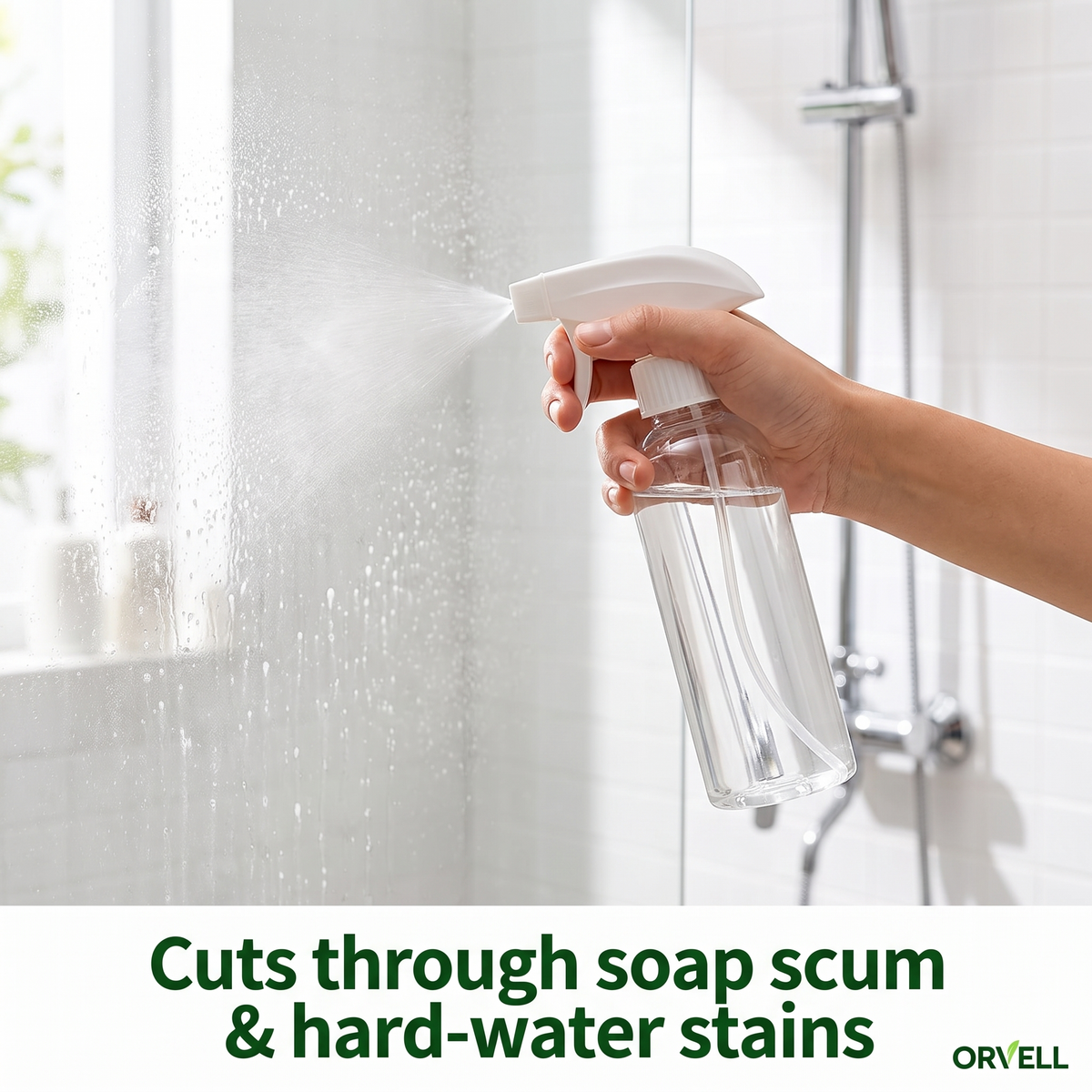 Hand spraying Orvell multi-surface cleaner on shower glass to cut through soap scum
