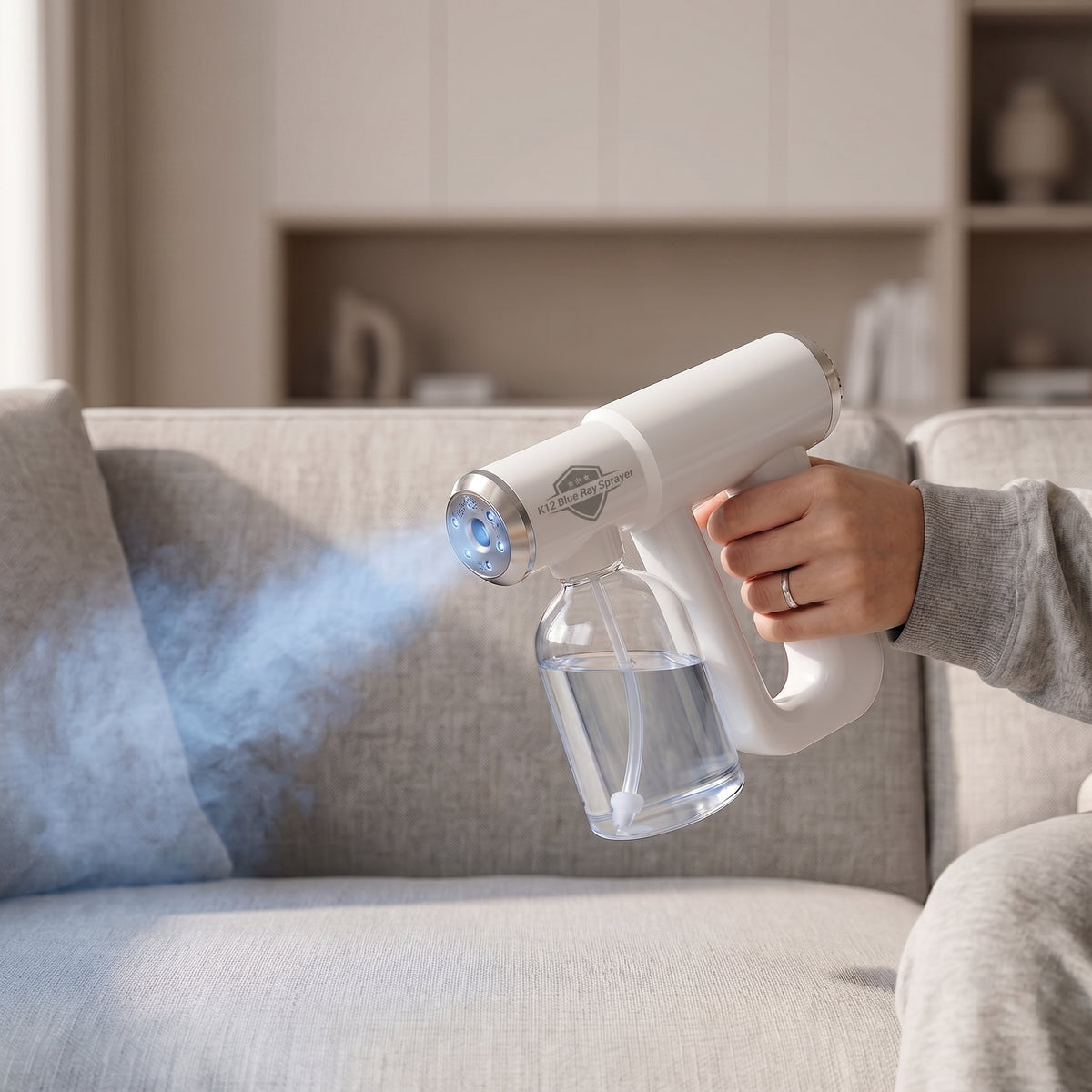 Orvell Odor Eliminator misting a fabric sofa in a living room